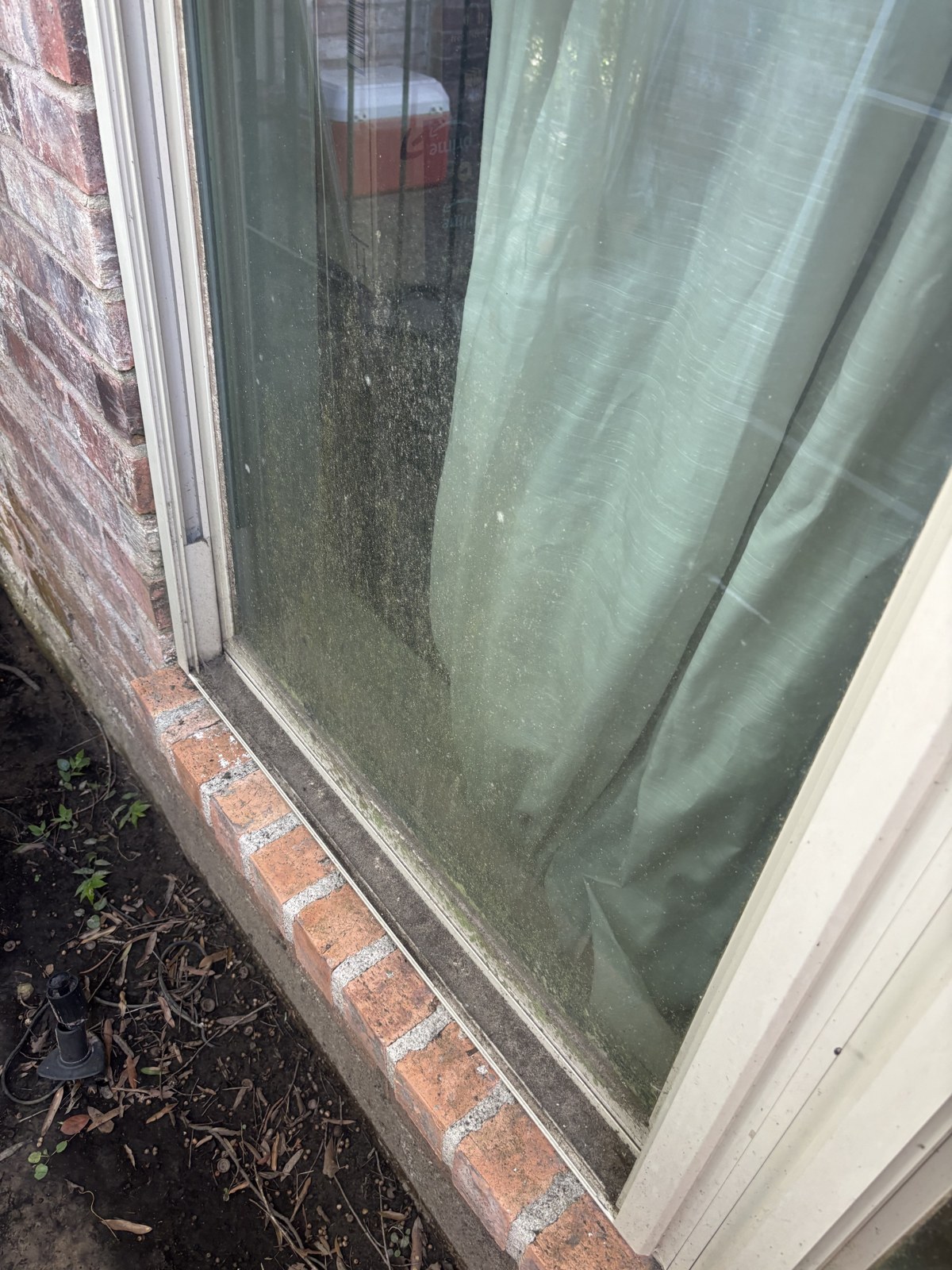 Dirty exterior window with mineral buildup before cleaning