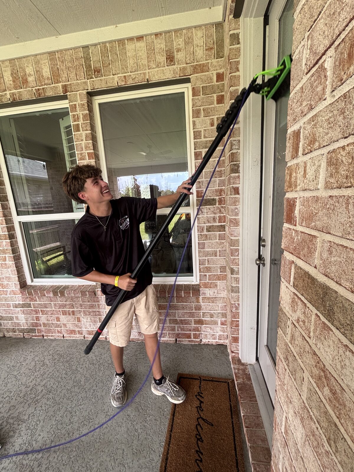 ClearView technician cleaning a front entry window